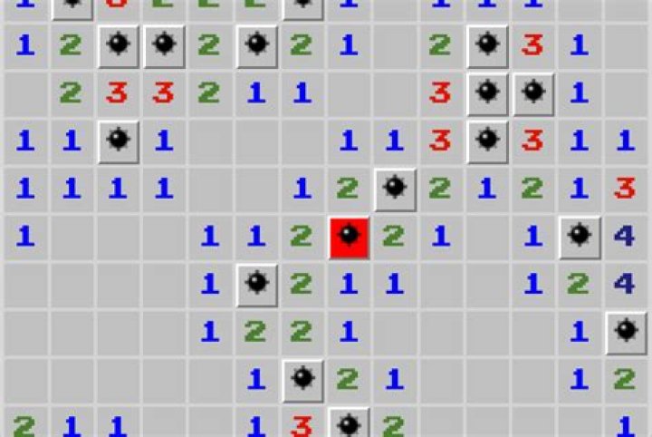 How do you reveal mines in Minesweeper?